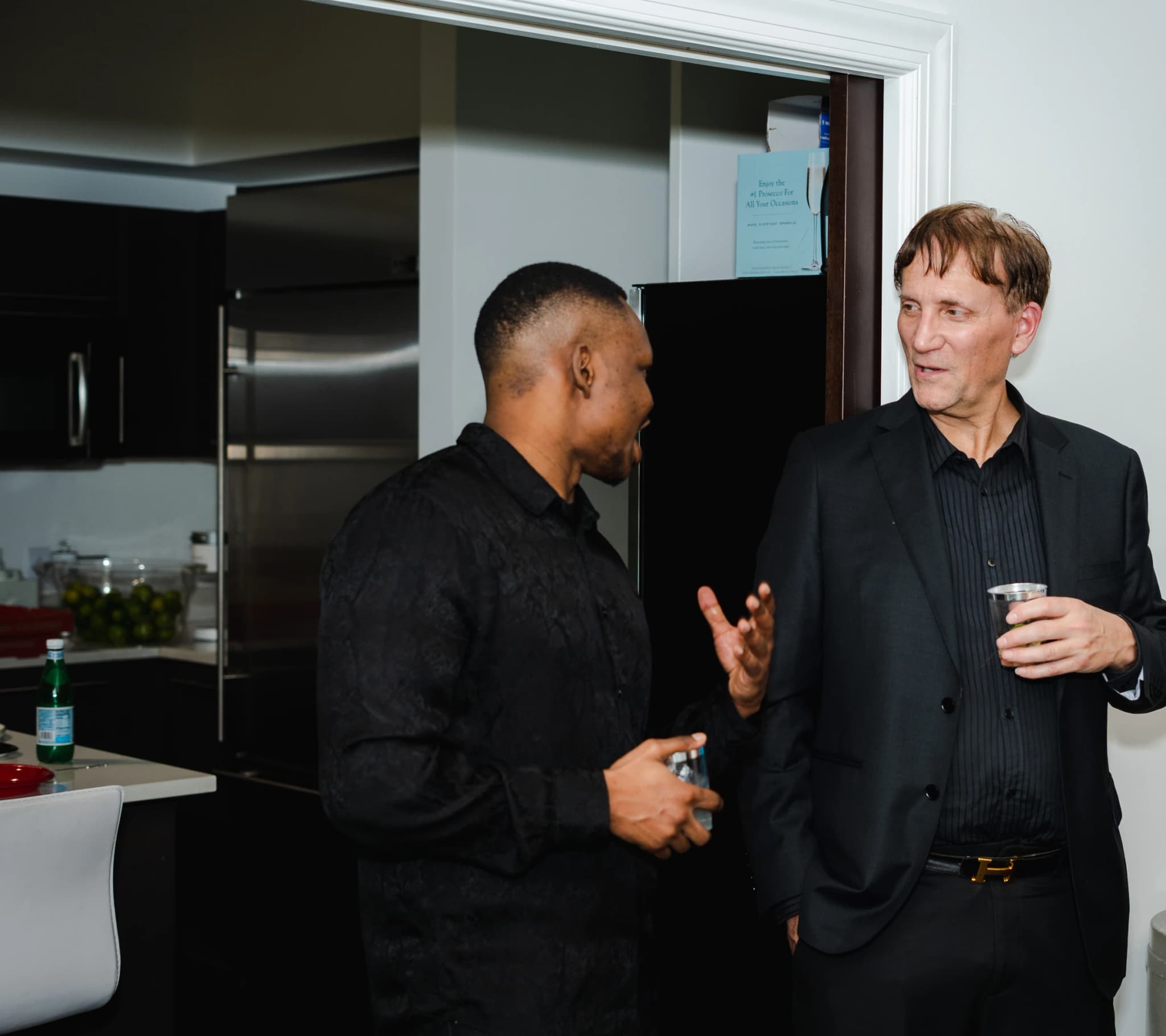 Dico in conversation at an evening reception