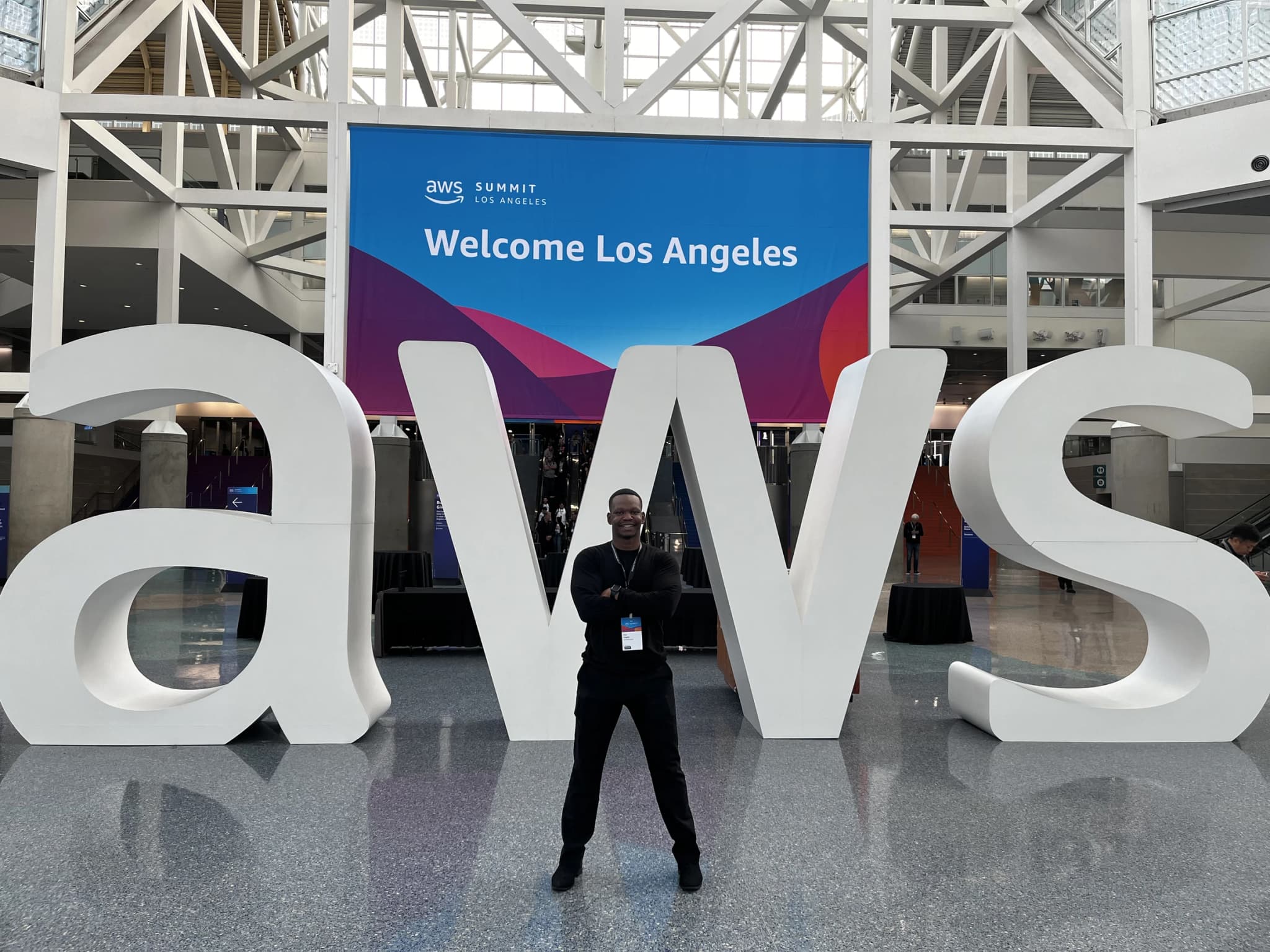 Dico in front of giant AWS letters at AWS Summit Los Angeles