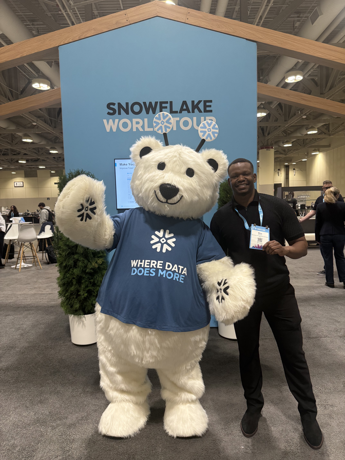 Dico beside the Snowflake mascot at Snowflake World Tour