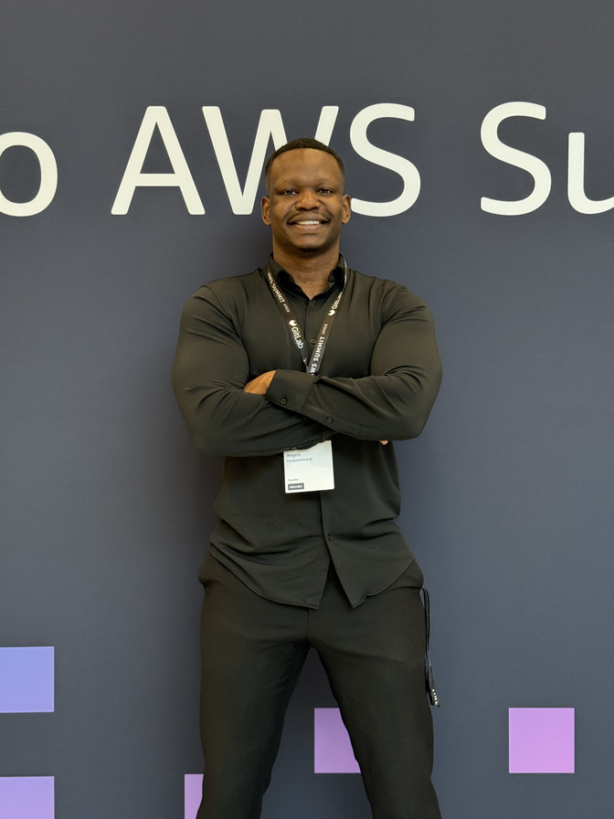 Dico in front of an AWS Summit backdrop
