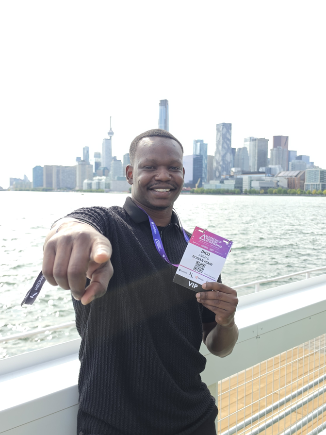 Dico on the Toronto waterfront wearing a Blockchain Futurist Conference badge