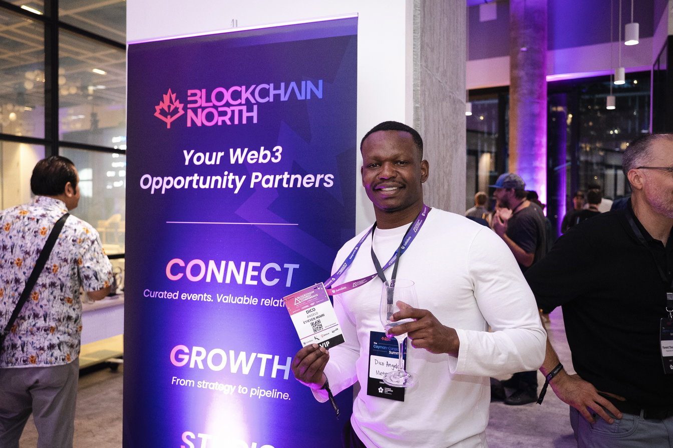 Dico beside a Blockchain North banner at a networking event