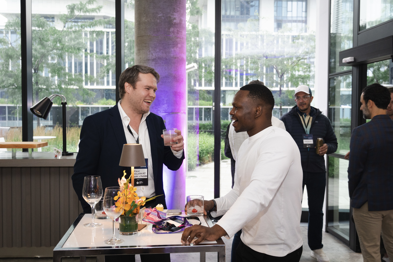 Dico in conversation with another attendee at a networking reception
